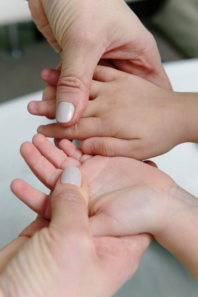 Person Holding the Hands of baby